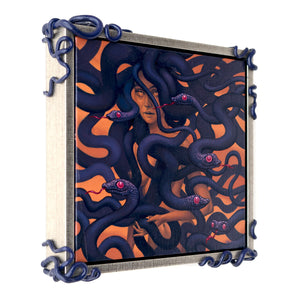 Side view of Framed painting with sculptural serpentine corners. The painting on red ochre of a female medusa figure enshrouded with purple snakes with their red tongues out.